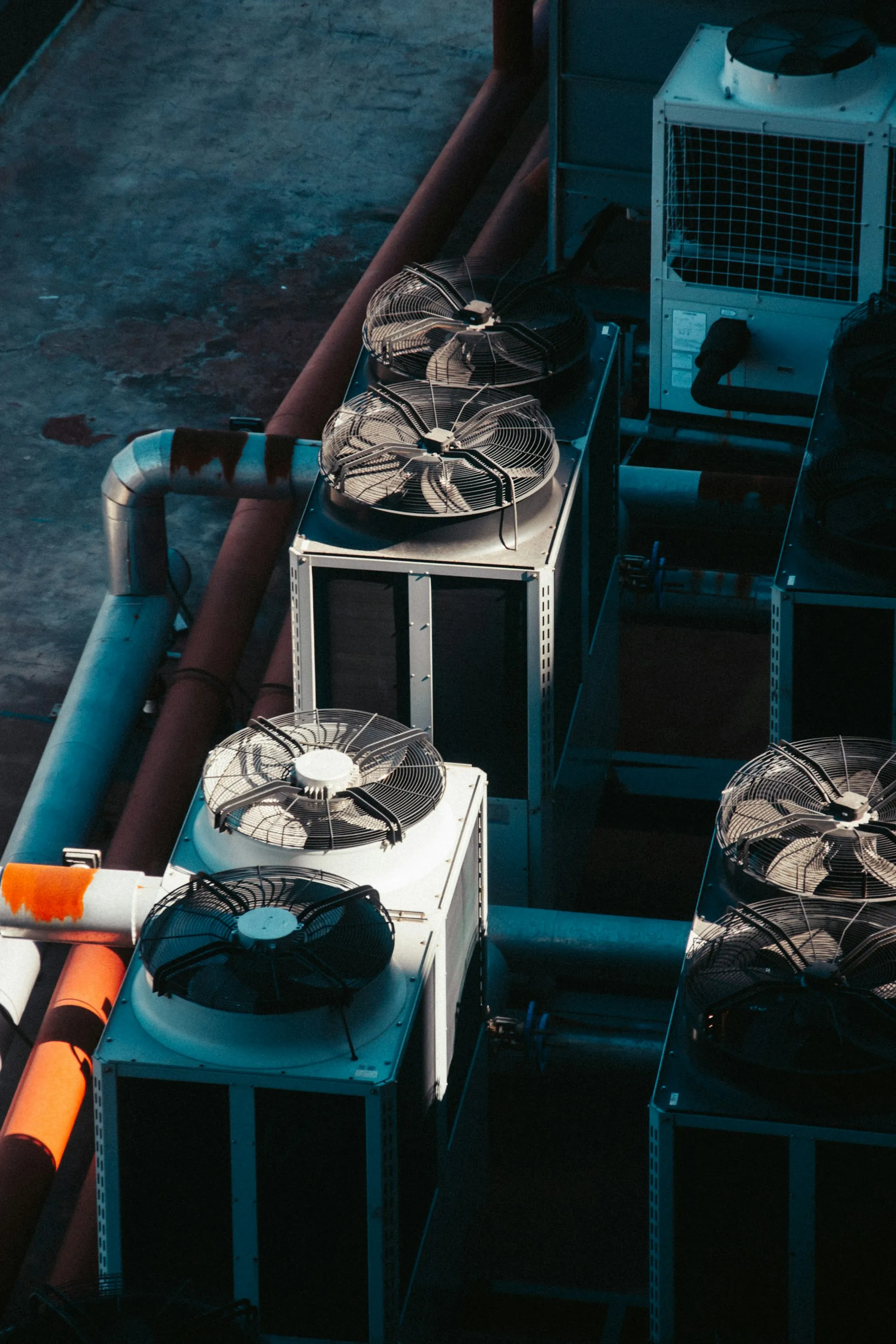 Commercial condenser units with large fans and pipes