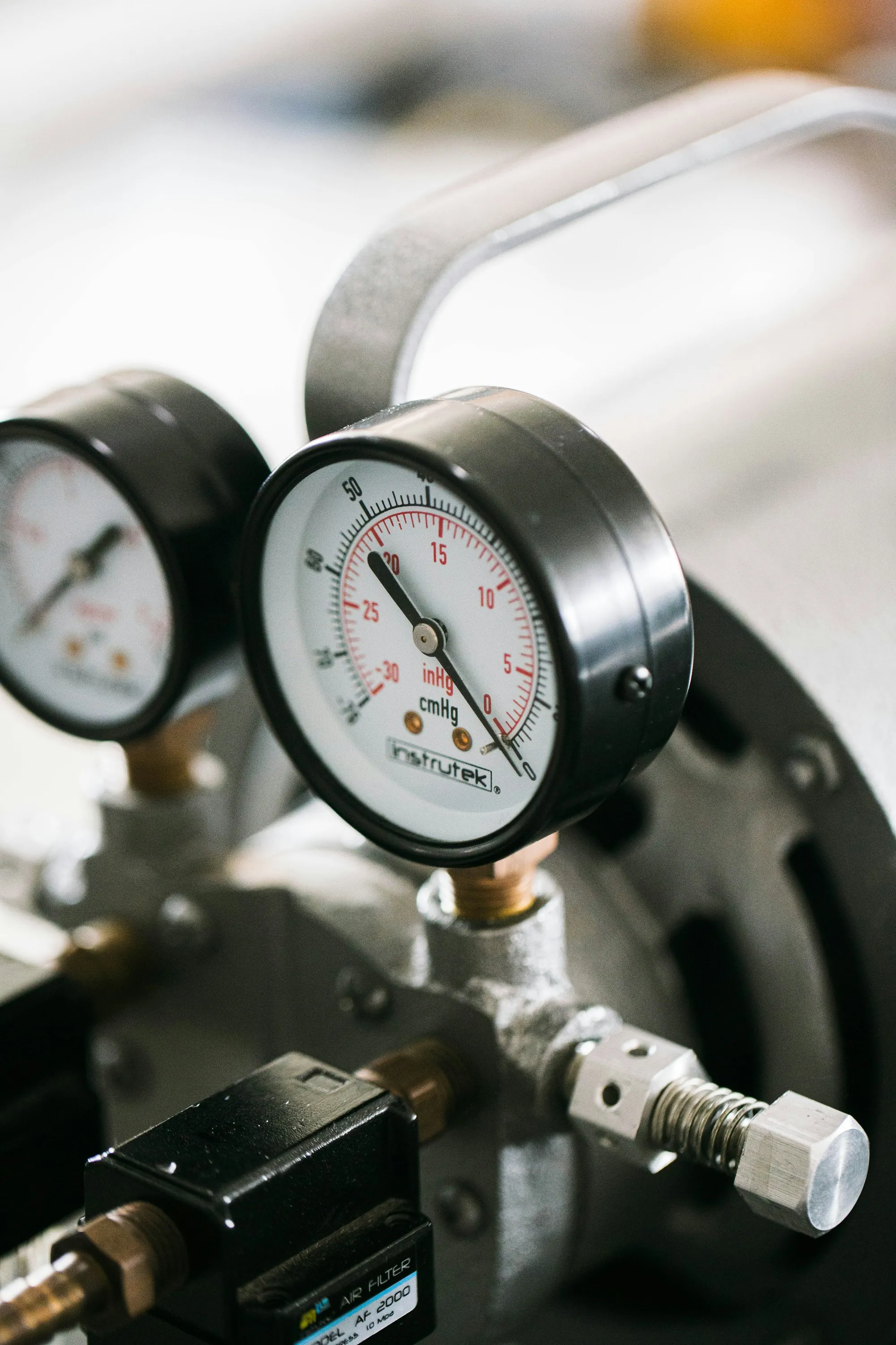 Pair of round pressure gauges on equipment